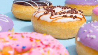 Colorful sweeties donuts over blue table background.