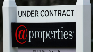 A sign announcing that a home is under contract is displayed