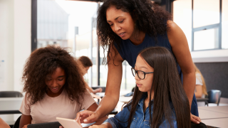 Teacher helping students