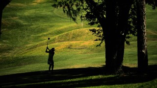 Golfer in the shadows.