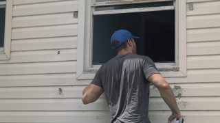 Alex Jandick looks for suspected squatters inside a home in St. Petersburg, Florida.